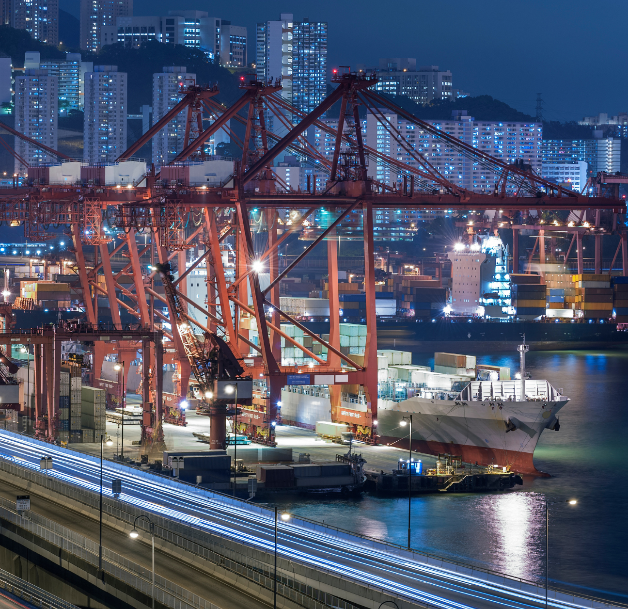 Port with shipping containers being tracked using supply chain visibility software. 