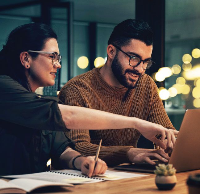 man and woman work at computer to Send ASNs & Milestones from a Logistics Service Provider to a Shipper