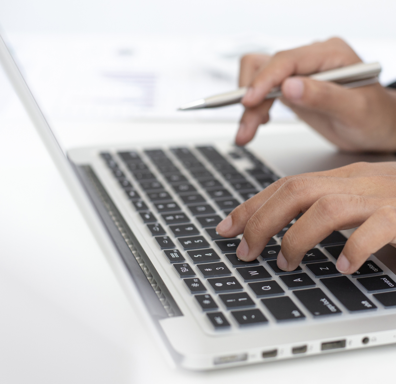 Supply chain expert using laptop to connect their supply chain systems.